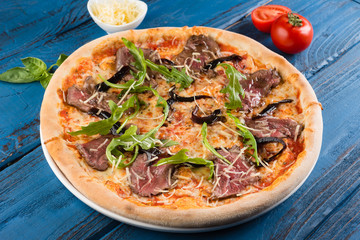 Delicious and fresh pizza with cheese and greens