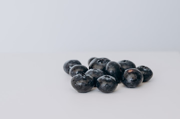 juicy fresh blueberries lay on a white background
