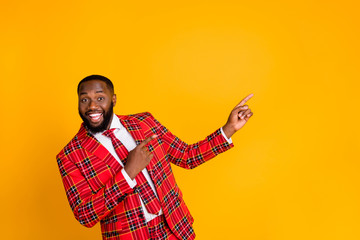 Photo of funny sales person dark skin guy indicating fingers side empty space advising novelty...