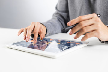 Close-up of female hands touching screen of tablet