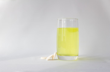 Vitamin C tablets are water soluble. Glass cup. An orange drink is good for boosting the body's immunity and resistance to viruses. Avitaminosis. Spring.