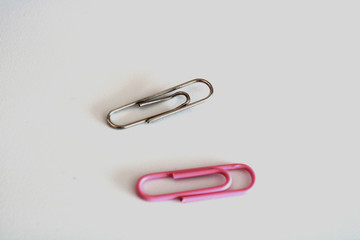 2 paper clips on a white background