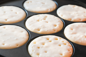 cooking pancakes in a pan . template for the recipe. the process of cooking food