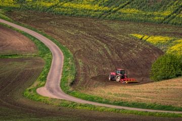 Tractor in the moravian field at spring near Karlin, Chech Republic