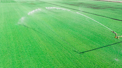 Automated irrigation system on agricultural field. Drone view.