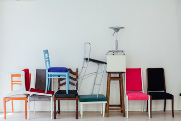 different multicolored chairs in the interior of the white room