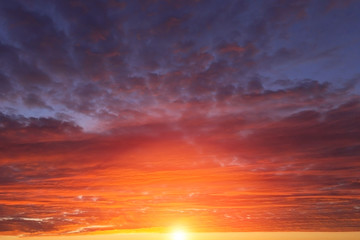 Epic dramatic sunset, sunrise red orange sky with clouds, sun and sunlight
