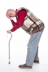 Unhappy senior man with a cane suffering from pain in back or reins over white background