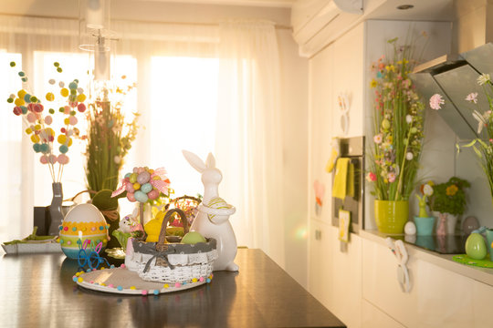 Easter theme. Easter decorations. Easter eggs in basket and easter bunny. Bouquet of spring flowers.