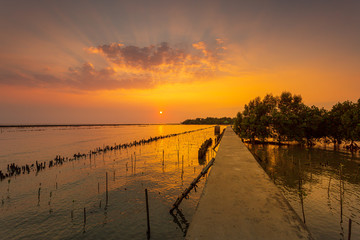 Sunset over the lake in the village ,The bridge stretches out to sea and sunsets in the evening , 
