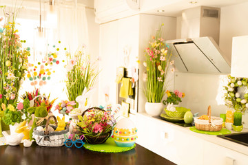 Easter theme. Easter decorations. Easter eggs in basket and easter bunny. Bouquet of spring flowers.