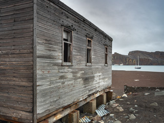 old wooden whale hounters house and yacht at sea  in Antarctica