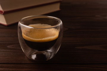 .Coffee and books. Natural wood background.