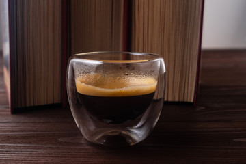 .Coffee and books. Natural wood background.