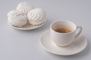 .?offee and white marshmallows on a white background