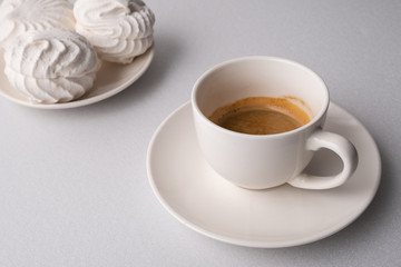 .?offee and white marshmallows on a white background