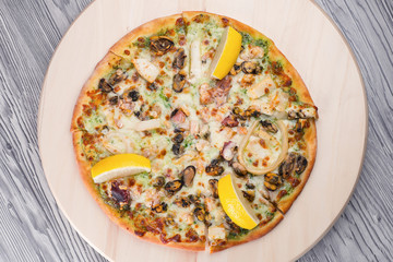 Pizza with cheese and lemon