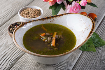 Pea soup in a restaurant on a white wooden table