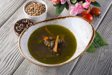 Pea soup in a restaurant on a white wooden table