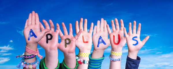 Children Hands Building Colorful German Word Applaus Means Applause. Blue Sky As Background