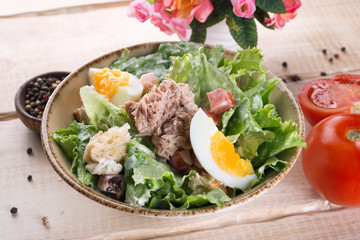 Salad with greens, meat, eggs and tomatoes