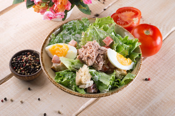 Salad with greens, meat, eggs and tomatoes