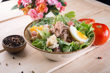 Salad with greens, meat, eggs and tomatoes