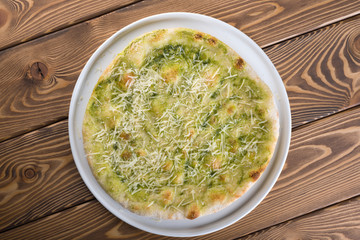 Delicious pizza with cheese, olives and greens