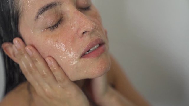 sad woman showering relaxing from a stressful day in slowmotion
