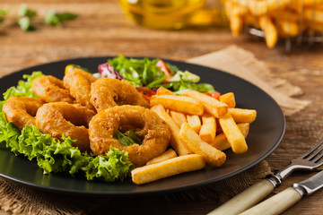 Roasted squid rings with fries.