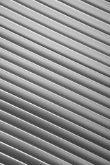 Close-up grey window blind shot at an angle