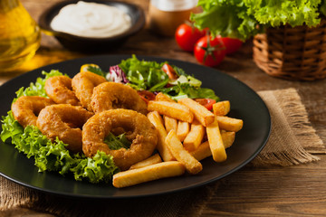 Roasted squid rings with fries.