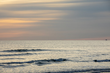 Fototapeta na wymiar Seascape at sunset with muted colours over a tranquil sea on the south coast of England.