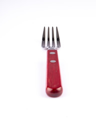 Only a red fork on table