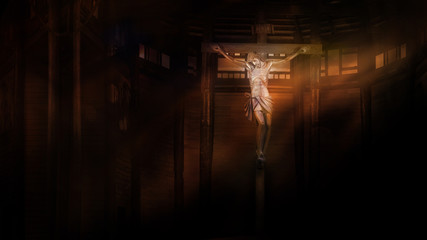 crucifix, jesus on the cross in church with ray of light in the darkness