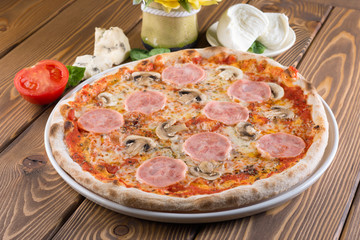 Delicious pizza with cheese, tomatoes, olives and greens