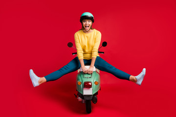 Full length body size view of her she nice attractive lovely crazy amazed cheerful cheery girl sitting on moped fooling having fun time isolated on bright vivid shine vibrant red color background