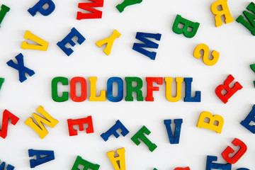 Series "Color": Background made from colorful wooden letters, word colorful in the middle
