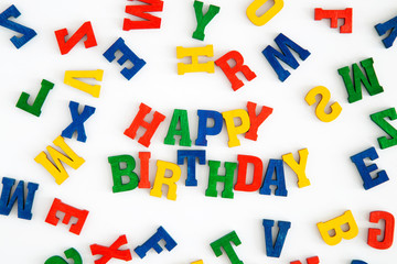 Happy Birthday in wooden letters on white background
