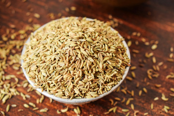 Dried Fennel Seeds in a Silver bowl on wooden old Table. Rustic Style