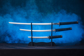 Three swords on a stand with exposed blades