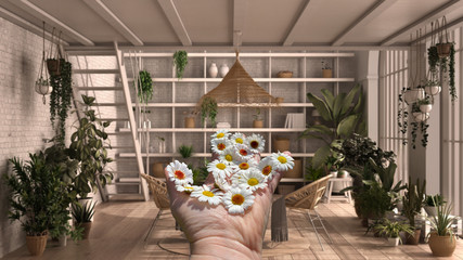 Woman's hand holding daisies, spring and flowers idea, over modern conservatory, winter garden, lounge with rattan armchair and table. Iron staircase, parquet floor, interior design