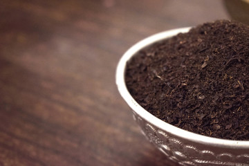 Dry Tea in a Silver bowl on wooden old Table. Rustic Style