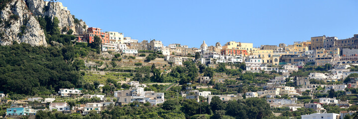 Obraz premium Capri - Italy: Panoramic view of the island with the town on the top of the hill.