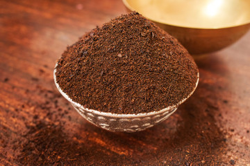 Dry Tea in a Silver bowl on wooden old Table. Rustic Style