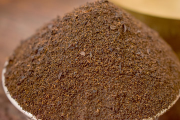 Dry Tea in a Silver bowl on wooden old Table. Rustic Style