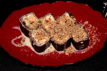 Fruit in a chocolate pancake with condensed milk and nuts.
