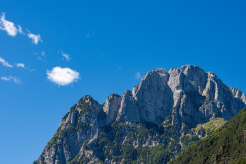Jerebica or Cima del Lago. Mountain peak of the Julian Alps on the border between Slovenia and Italy, from Log pod Mangartom village, in Triglav National Park, Slovenia, Europe