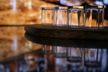 Whiskey with ice or brandy in a glass on a bar tap in a traditional style pub. Whiskey with ice in a glass.