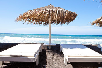 lounge chairs and umbrella on the beach